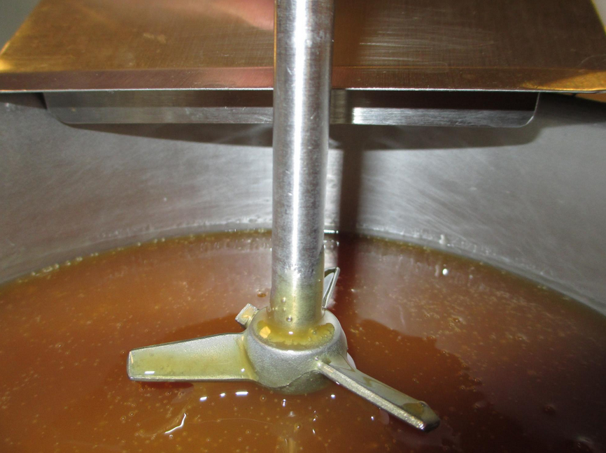 A vat of dextrin liquid glue getting mixed.